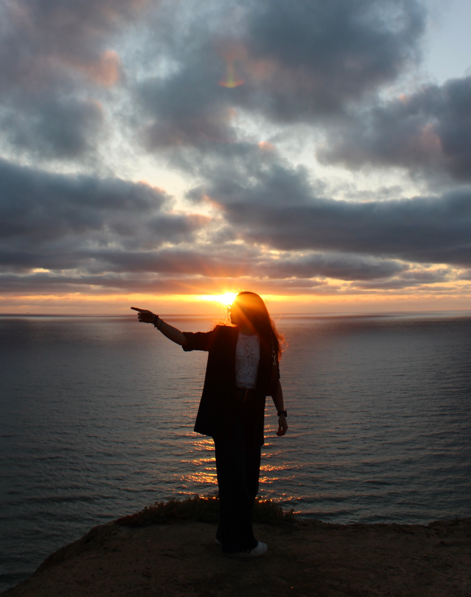 Silhouette pointing at sunset